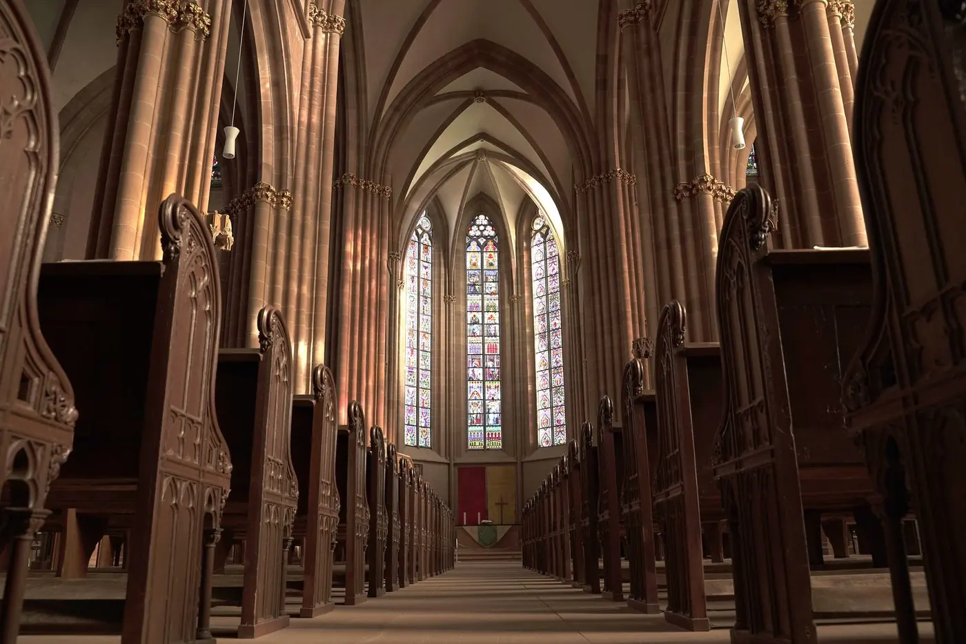 Warm light falling across the wooden pews inside St Peter's church